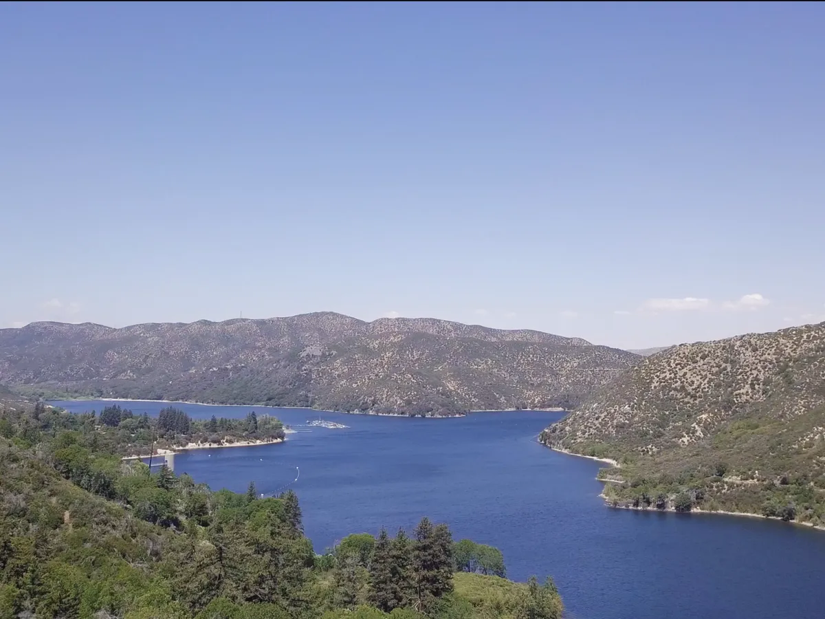 View over a mountain lake and forested hills in the San Bernardino Mountains